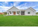 Charming single-story home with a well-manicured lawn and a welcoming front porch at 1679 E County Road 462, Wildwood, FL 34785