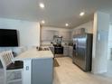 Modern kitchen featuring stainless steel appliances and gray cabinetry at 1799 Post Oak Dr, Davenport, FL 33837