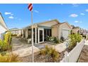 Beautiful villa with a screened lanai, lovely landscaping, stone-paved patio and white picket fence at 2495 Birch Ave, The Villages, FL 32162