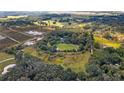 Aerial view of property with a house, large grassy areas, trees, and distant pastures at 2610 Stephens Rd, Groveland, FL 34736