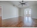 Bright living room with wood flooring, fan, and view to the next room at 26608 E Cove Dr, Tavares, FL 32778