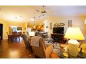 Inviting living area with hardwood floors, ceiling fan, comfortable seating, and an open view to the kitchen at 2682 Edwards Ln, The Villages, FL 32162