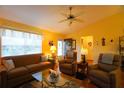 Bright living room featuring wood floors, a large window and comfortable seating at 2682 Edwards Ln, The Villages, FL 32162