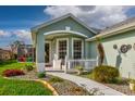 Inviting front porch with white picket fence, decorative walkway, and colorful garden at 27004 Nature View St, Leesburg, FL 34748