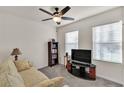 Cozy living room featuring neutral walls, carpeted floors, and a ceiling fan at 28026 Cypress Springs Loop, Okahumpka, FL 34762