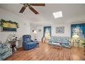 Inviting living room with hardwood floors, ceiling fan, and plenty of natural light at 3323 Manatee Rd, Tavares, FL 32778