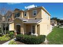 Side view of a well-maintained, two-story townhome with lush landscaping and sunny exposure at 339 Winter Nellis Cir, Winter Garden, FL 34787