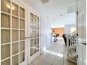 Bright foyer with tiled floors, French doors, and an open view to the kitchen and living areas at 339 Winter Nellis Cir, Winter Garden, FL 34787