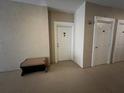 Hallway featuring neutral paint, clean lines, and an ottoman with a storage bench at 3605 Conroy Rd # 535, Orlando, FL 32839