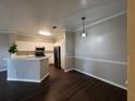 Stylish kitchen showcasing stainless steel appliances, quartz countertops, and modern lighting at 3605 Conroy Rd # 535, Orlando, FL 32839