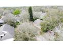 An aerial view of tree-lined neighborhood homes at 3847 Eversholt St, Clermont, FL 34711