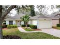 Inviting single-story home with lush landscaping, paver walkway, and two-car garage at 3847 Eversholt St, Clermont, FL 34711