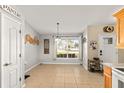 Bright dining area next to the kitchen, features a large window and neutral decor at 40707 E Ninth Ave, Umatilla, FL 32784