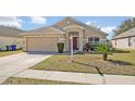 Well-kept home with a two-car garage, neat landscaping, and a clear 'For Sale' sign at 4078 Waltham Forest Dr, Tavares, FL 32778