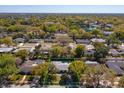 Aerial view of home with a private pool surrounded by lush greenery in a residential neighborhood at 4830 Tellson Pl, Orlando, FL 32812