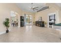 Spacious living room with tile flooring, sliding glass doors, and backyard access at 4955 Ne 124Th Rd, Oxford, FL 34484