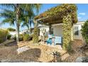 Cozy backyard seating area under a vine-covered pergola, perfect for outdoor relaxation at 544 Audrey Ln, The Villages, FL 32162