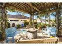 Beautiful backyard seating area with a fire pit and comfortable seating for outdoor entertainment at 544 Audrey Ln, The Villages, FL 32162