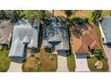 High angle shows the home's roof, landscape and the surrounding neighborhood at 544 Grand Vista Trl, Leesburg, FL 34748