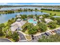 Aerial view showcasing a community pool, gazebo, clubhouse, and parking, all surrounded by lush landscaping at 559 Juniper Springs Dr, Groveland, FL 34736