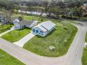 Aerial view of a single-story home with a two-car garage, and close to a green space at 701 Brigadoon Cir, Leesburg, FL 34788