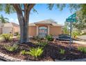 Attractive single-story home featuring mature landscaping and a decorative bench on corner lot at 922 Cancun Ct, The Villages, FL 32159