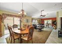 Spacious living room combining dining area with a well-lit seating area, perfect for entertaining guests at 932 Medira Dr, The Villages, FL 32159