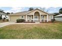 Charming single-story home with manicured front yard and attached garage at 11053 Se 174Th Loop, Summerfield, FL 34491