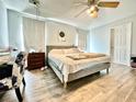 Bedroom featuring hard wood floors, ceiling fan, curtains and plenty of space at 1209 Demoiselle St, Groveland, FL 34736