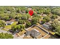 Aerial view of the property showcasing its location within a tree-filled, quiet neighborhood at 1212 Windy Bluff Dr, Minneola, FL 34715