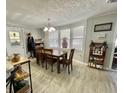 Cozy dining area with wood-style laminate flooring and natural light at 127 Hibiscus Way, Leesburg, FL 34748