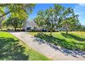 Sprawling home with a long driveway, lush landscaping, and attached garage at 12802 Amber Ave, Clermont, FL 34711
