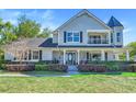 Charming two-story home with a welcoming front porch and well-manicured lawn at 12802 Amber Ave, Clermont, FL 34711