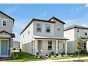 Stylish two-story home with modern design, landscaped yard, and inviting front porch at 140 S Zuni Rd, St Cloud, FL 34771