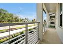 View from porch with modern railing, showcasing neighborhood street and landscaping at 140 S Zuni Rd, St Cloud, FL 34771