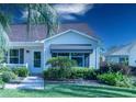 Up-close view of the home's entrance and the surrounding landscaping at 1617 Lakewood Dr, The Villages, FL 32162