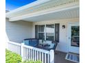 Cozy front porch with chairs and a table, perfect for relaxing outdoors at 1617 Lakewood Dr, The Villages, FL 32162