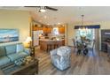 Open-concept living space with hardwood floors, ample seating, and natural light at 1617 Lakewood Dr, The Villages, FL 32162
