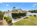 Well maintained home featuring manicured lawn, trimmed hedges, and attached two-car garage at 1622 Valley Falls Way, The Villages, FL 32162
