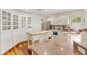 Cozy kitchen featuring white cabinetry, granite countertops, and stainless steel appliances at 1622 Valley Falls Way, The Villages, FL 32162