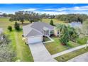 Inviting one-story home with a two car garage, well-maintained lawn, and beautiful landscaping at 16611 Spring Park Dr, Clermont, FL 34711
