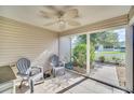 Enclosed Lanai with tile flooring and ceiling fan with 2 chairs at 16865 Se 94Th Sunnybrook Cir, The Villages, FL 32162
