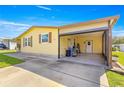 This single-story home has a large open garage with a concrete driveway at 1854 W Schwartz Blvd, Lady Lake, FL 32159