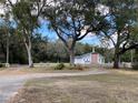 White church with cross and steeple stands among shady trees at 2416 Spring Lake Rd, Fruitland Park, FL 34731