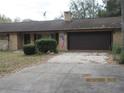 Charming single-story home with an attached garage and a well-manicured front yard at 2416 Spring Lake Rd, Fruitland Park, FL 34731