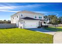 Charming two-story house with attached garage, well-maintained lawn, and inviting curb appeal at 2510 Glacier Express Ln, Tavares, FL 32778