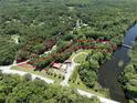 Stunning aerial view of a vast property nestled amidst lush greenery, showcasing a tranquil and private setting at 2886 N C 470, Lake Panasoffkee, FL 33538