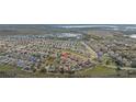 Beautiful aerial shot of a residential community with meticulously designed streetscapes at 303 Red Kite Dr, Groveland, FL 34736