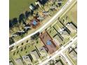 Aerial view showcasing property lots with clearly marked boundaries, adjacent to the lake and a quiet neighborhood at 3339 Landing Vw, Tavares, FL 32778