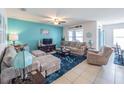 Inviting living room with comfortable sectional sofa, ceiling fan and coastal decor at 3339 Landing Vw, Tavares, FL 32778